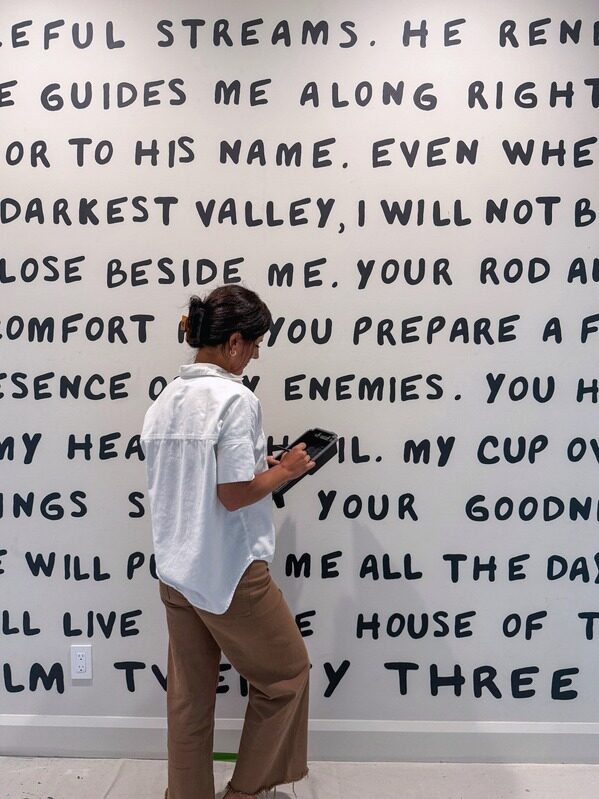 The finished hand-painted scripture wall spanning the full hallway