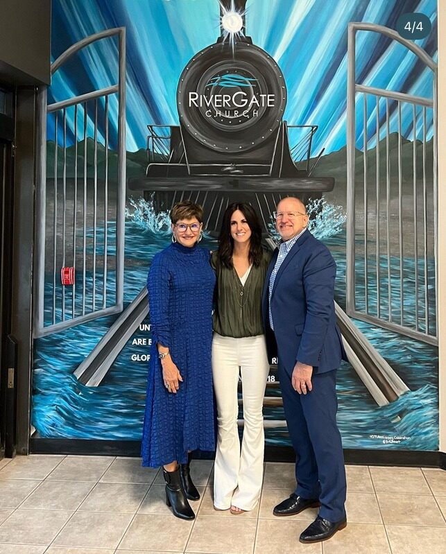 Brit Albin with the River Gate Church pastors in front of the finished mural